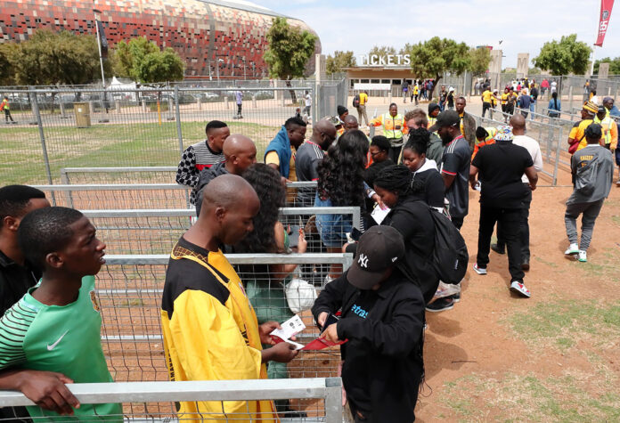 Football fans queueing to get into a match.