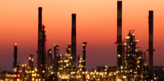 Chimneys of the Total Grandpuits oil refinery at sunset southeast of Paris