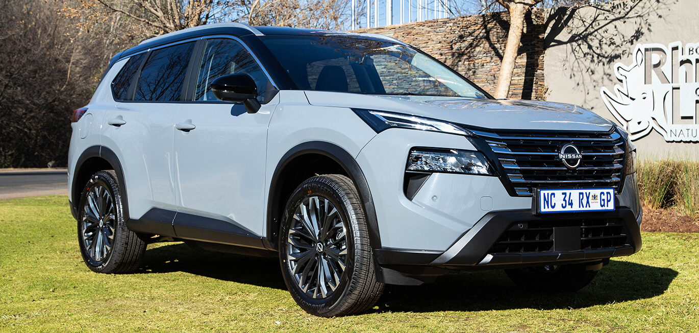Front view of the new silver Nissan X-Trail family SUV parked outdoors