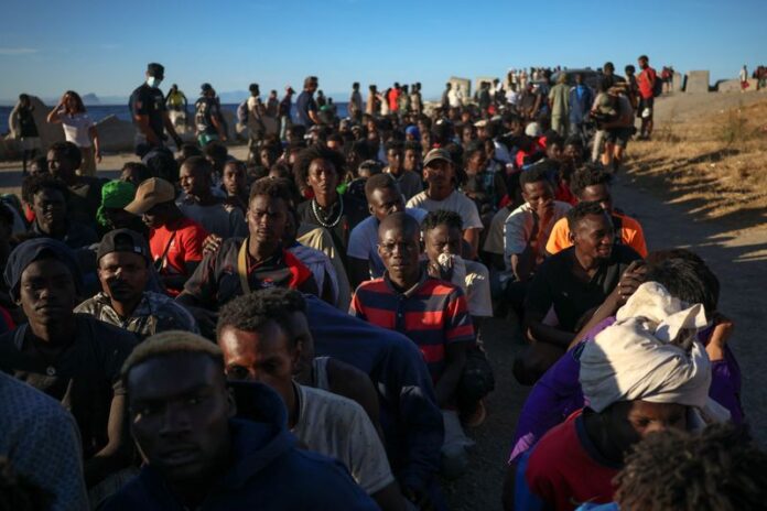 Migrants receive food and beverages from the Red Cross in Ceuta, Spain.