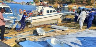 Rescue and recovery personnel on the shoreline of Lake Kariba during an operation to recover victims from a capsized ferry.