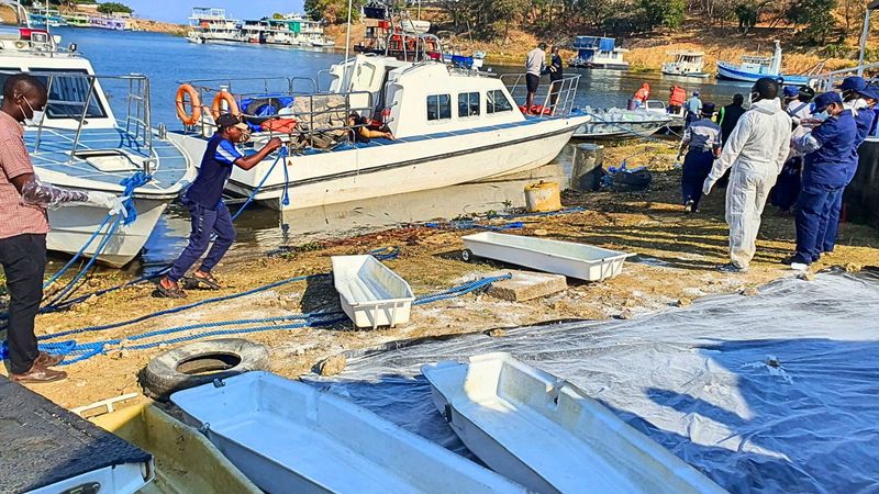 Rescue and recovery personnel on the shoreline of Lake Kariba during an operation to recover victims from a capsized ferry.