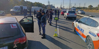 Gauteng police officers conducting a roadblock during a joint law enforcement operation against crime.