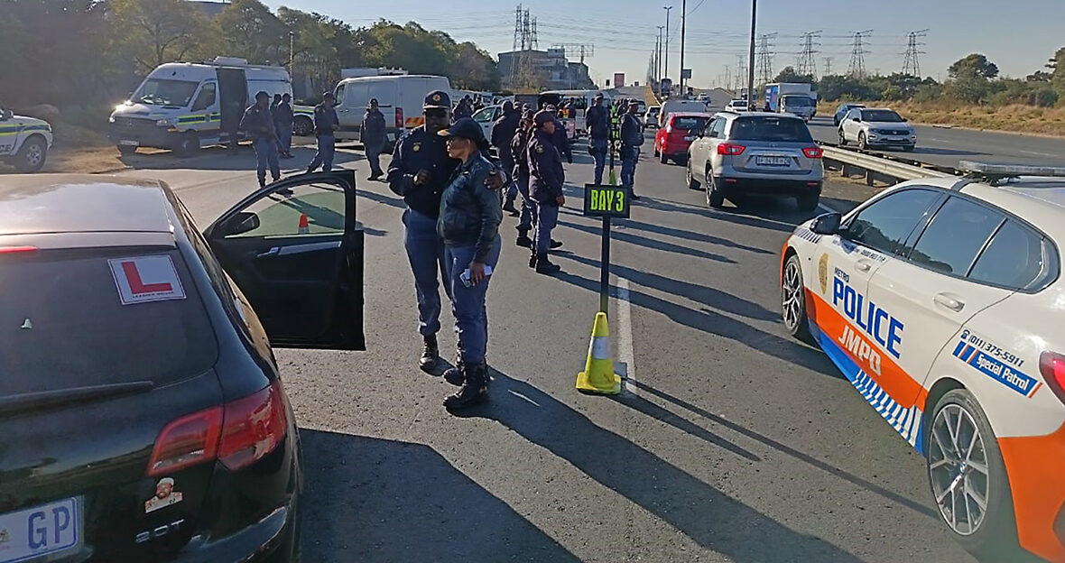 Gauteng police officers conducting a roadblock during a joint law enforcement operation against crime.