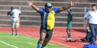 Milford FC head coach Xanti Pupuma celebrates on the sidelines during a soccer match
