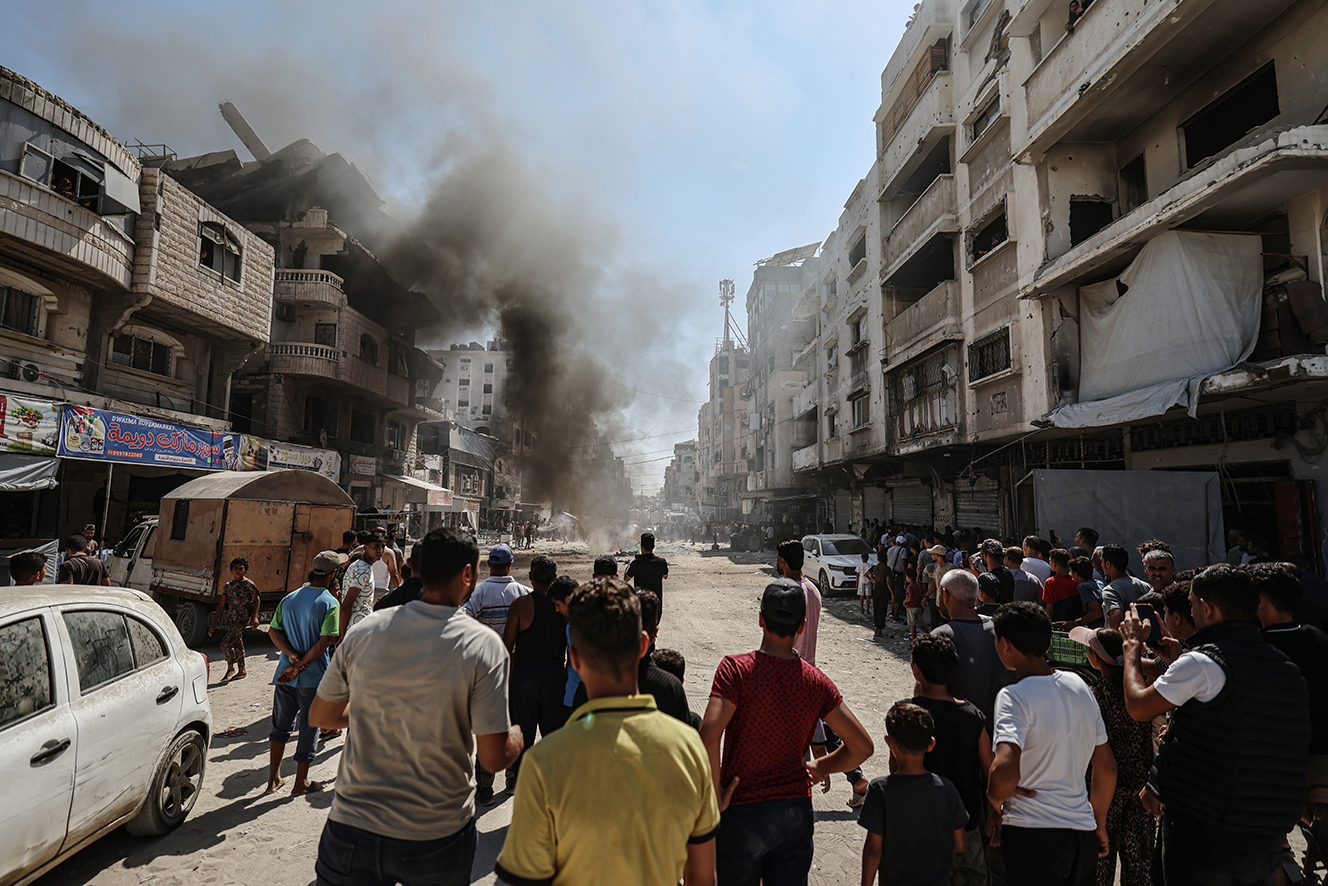 Burning vehicle on a street following an Israeli air strike in Gaza City's Tel al-Hawa neighborhood